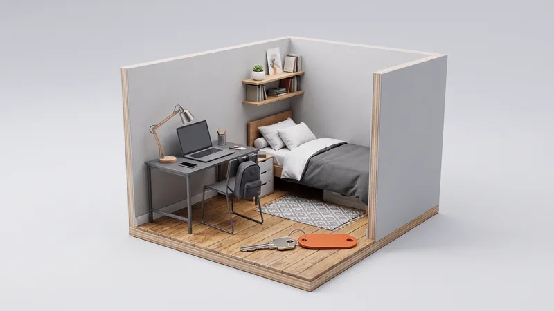 Maquete de um quarto de estudante com cama, mesa, notebook e mochila, e uma chave com chaveiro laranja em primeiro plano.